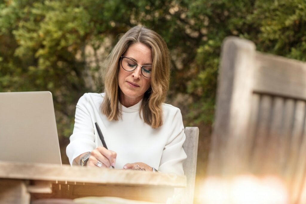 woman writing outside
