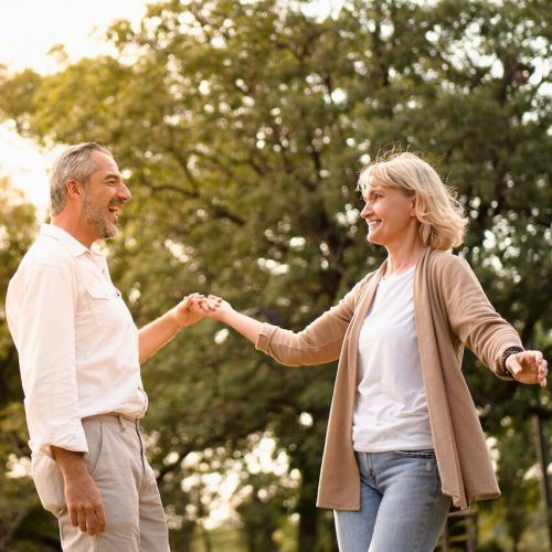 Senior couple dancing looking at each other